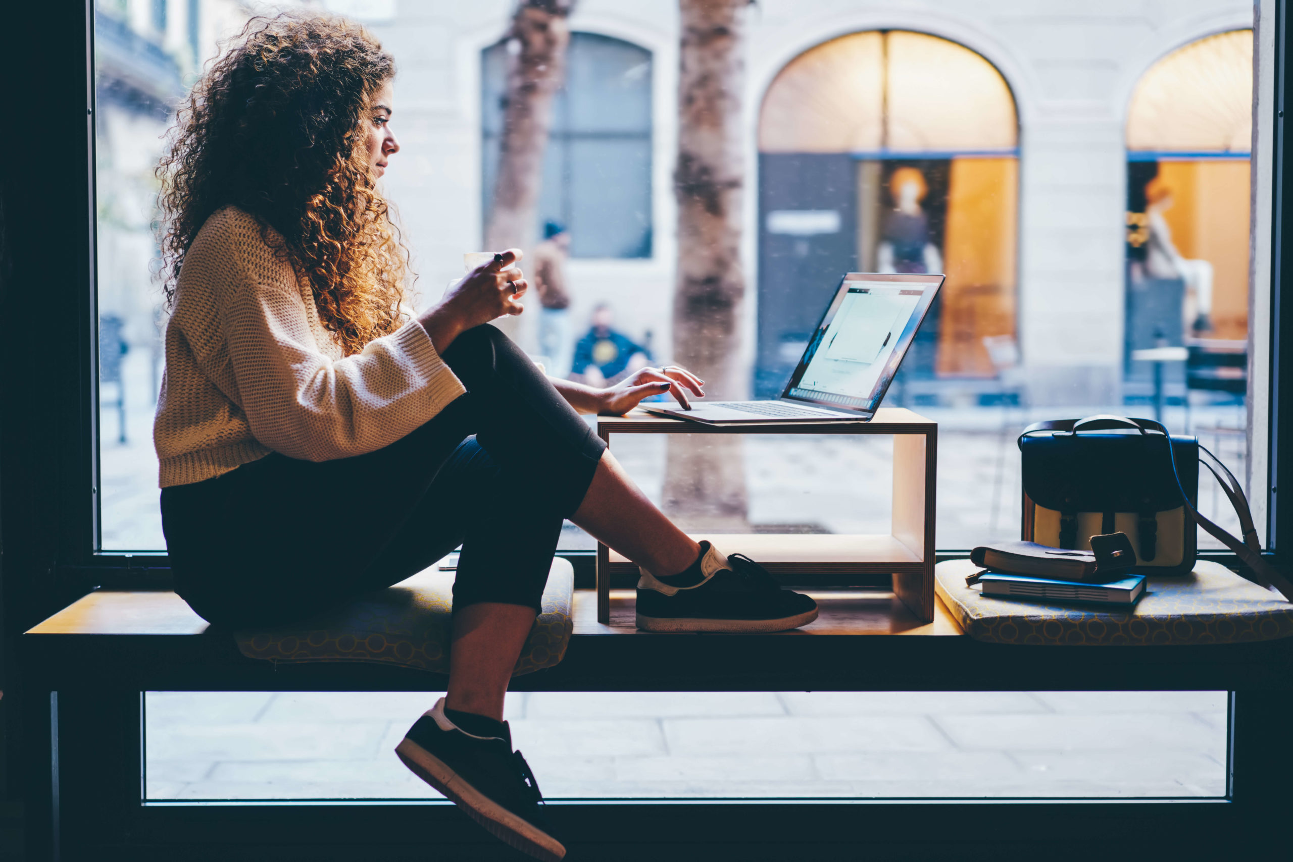 image young lady with curly hair reads online news